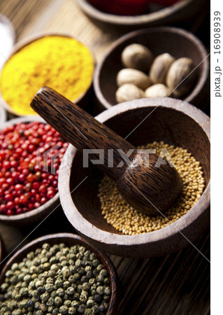 Assortment of spices in wooden bowl background Assortment of spices in wooden bowl background 16908939