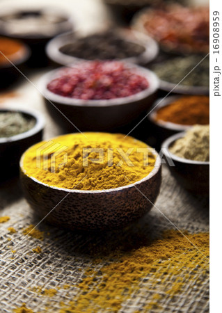 Assortment of spices in wooden bowl background Assortment of spices in wooden bowl background 16908959
