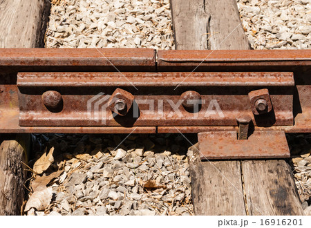Rusted railway ties linked with bolts 16916201