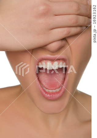 wailing woman shields her eyes from hand 16923162