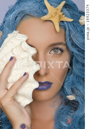 woman with blue hair, shells and open eyes 16923374