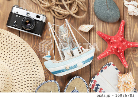 Travel and vacation items on wooden table 16926783