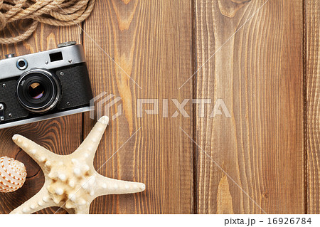 Travel and vacation items on wooden table Travel and vacation items on wooden table 16926784