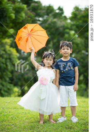 Asian  brother and sister having fun in the park 16931870