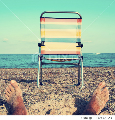 chair and young man on the beach, filtered 16937123