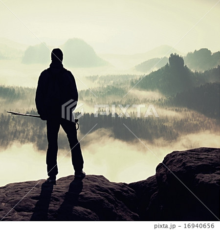 Misty day in mountains. Silhouette with poles 16940656