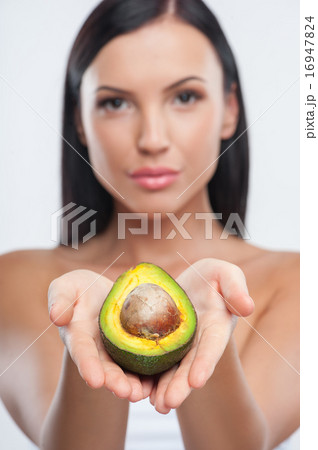 Cheerful young girl is showing exotic fruit Cheerful young girl is showing exotic fruit 16947824
