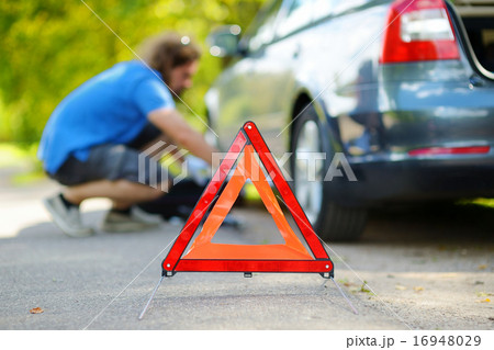 Red warning triangle sign on the road Red warning triangle sign on the road 16948029