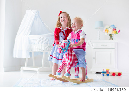 Kids playing with rocking horse Kids playing with rocking horse 16958520