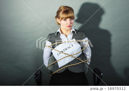 Upset businesswoman bound by contract terms. Upset businesswoman bound by contract terms. 16970312