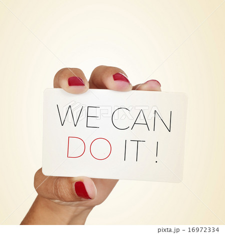 woman holds a signboard with the text we can do it woman holds a signboard with the text we can do it 16972334