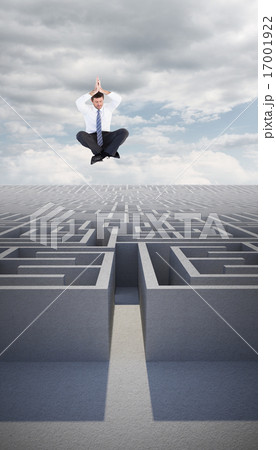 Composite image of businessman sitting in lotus pose with hands 17001922