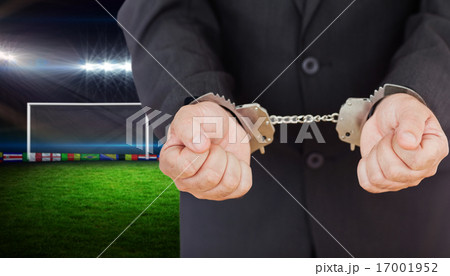 Composite image of handcuffed businessman 17001952
