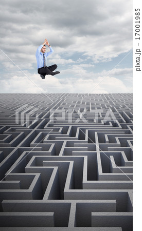 Composite image of calm businessman sitting in lotus pose with h 17001985