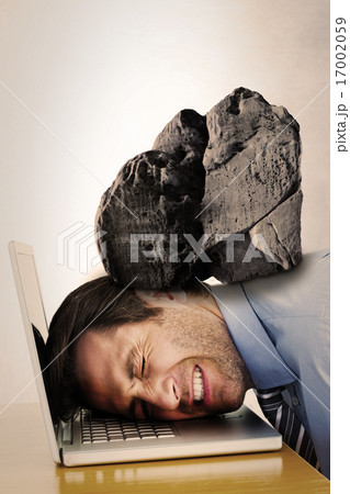 Composite image of businessman resting head on keyboard 17002059