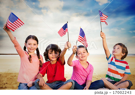 Composite image of children with american flags 17002243
