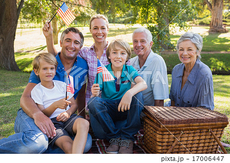 Happy family in the park and holding american flag Happy family in the park and holding american flag 17006447