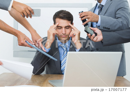 Worried businessman with head in hands 17007177