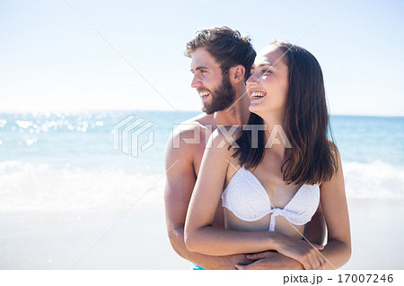Happy couple hugging and looking away Happy couple hugging and looking away 17007246