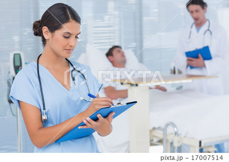 Doctors taking care of patient Doctors taking care of patient 17007514