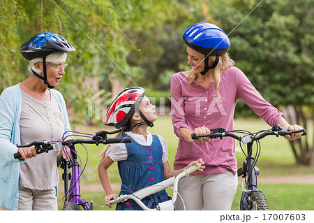 Happy multi generation family on their bike at the park 17007603