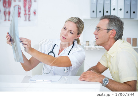 Doctor showing X rays to her patient 17007844