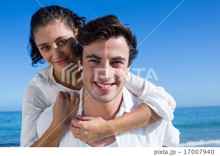 Handsome man giving piggy back to his girlfriend Handsome man giving piggy back to his girlfriend 17007940