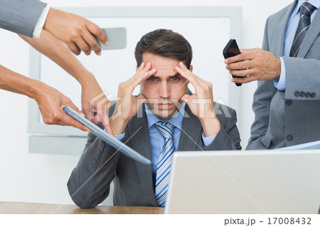 Worried businessman with head in hands 17008432