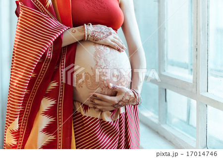 The pregnant woman belly with henna tattoo 17014746