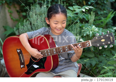 ピクニック ギターを弾く男の子の写真素材