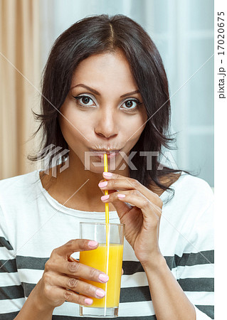 Attractive woman drinking orange juice. Attractive woman drinking orange juice. 17020675