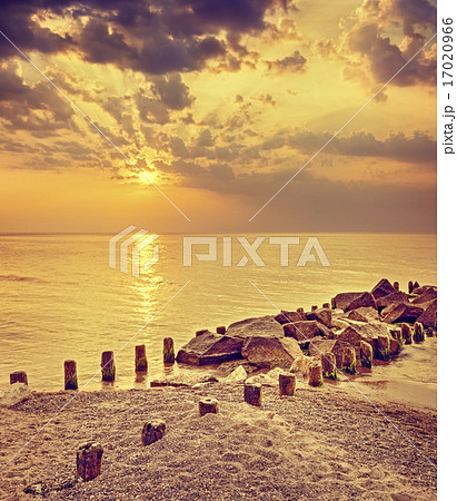 Retro toned dramatic sunset over beach. 17020966