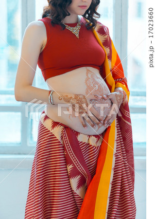 The pregnant woman belly with henna tattoo The pregnant woman belly with henna tattoo 17023660