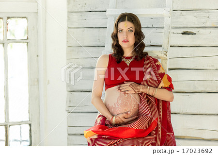 The pregnant woman belly with henna tattoo The pregnant woman belly with henna tattoo 17023692