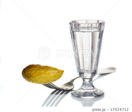 Glass of Russian vodka with pickled cucumber on a Glass of Russian vodka with pickled cucumber on a 17024712
