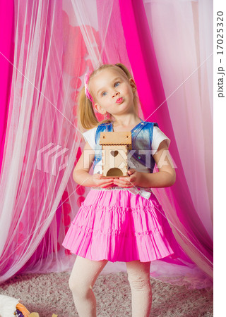 Little girl in a fashionable pink skirt 17025320