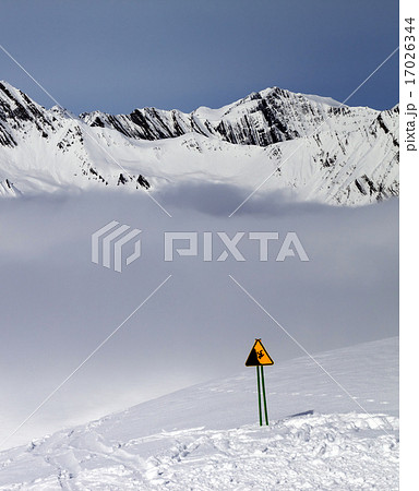 Warning sing on ski slope and mountains in fog 17026344