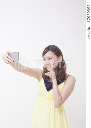 携帯電話で自撮りをする女性 携帯電話で自撮りをする女性 17029365