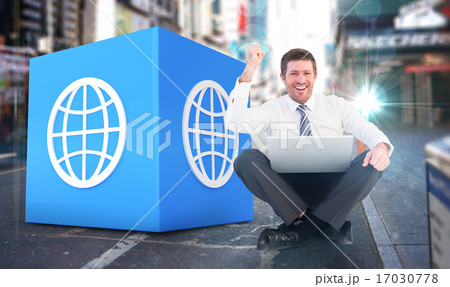Composite image of businessman using laptop and cheering 17030778