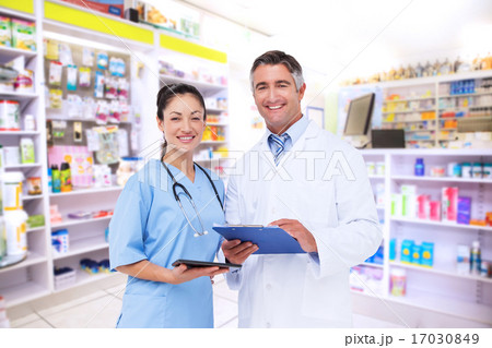 Composite image of doctor and nurse smiling at camera Composite image of doctor and nurse smiling at camera 17030849