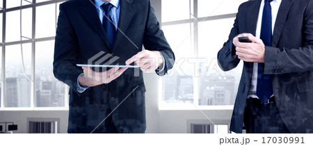 Composite image of focused businessman texting on his mobile pho Composite image of focused businessman texting on his mobile pho 17030991