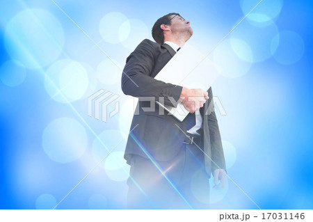Composite image of businessman looking up holding laptop Composite image of businessman looking up holding laptop 17031146