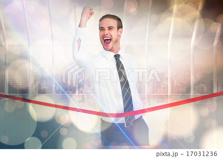 Composite image of businessman crossing the finish line while cl Composite image of businessman crossing the finish line while cl 17031236