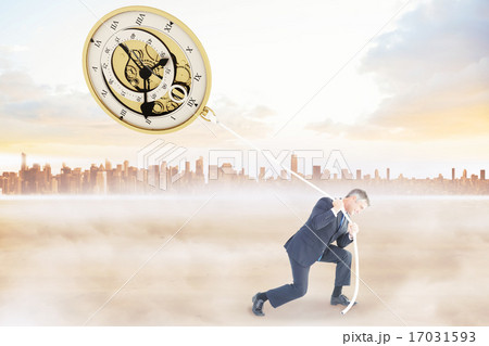 Composite image of classy businessman pulling a rope 17031593