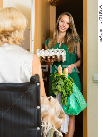 Female bringing food to invalid 17039596