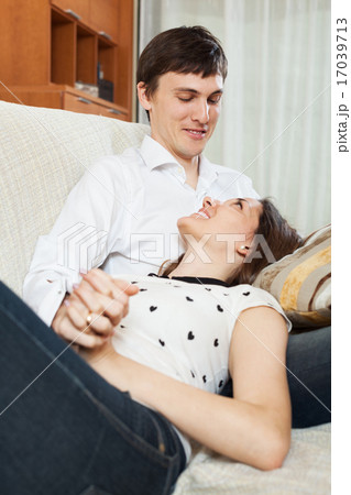 Happy young couple on sofa 17039713