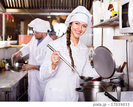 cooks cooking at professional kitchen 17039833