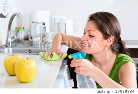 Woman doing chores in kitchen Woman doing chores in kitchen 17039834