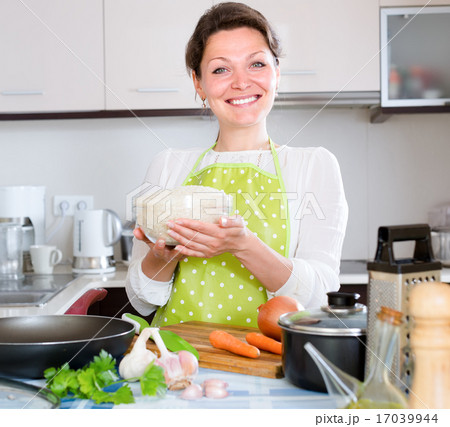 Woman cooking rice with vegetables Woman cooking rice with vegetables 17039944