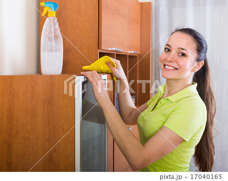 Girl dusting wooden furniture at home Girl dusting wooden furniture at home 17040165